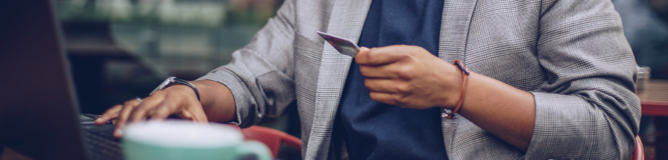 Casual professional holding a credit card.