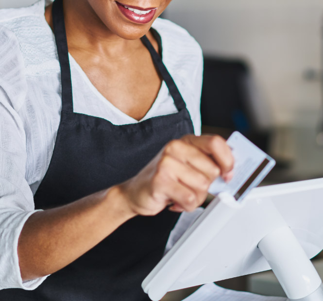 Employee swiping a debit card for payment,